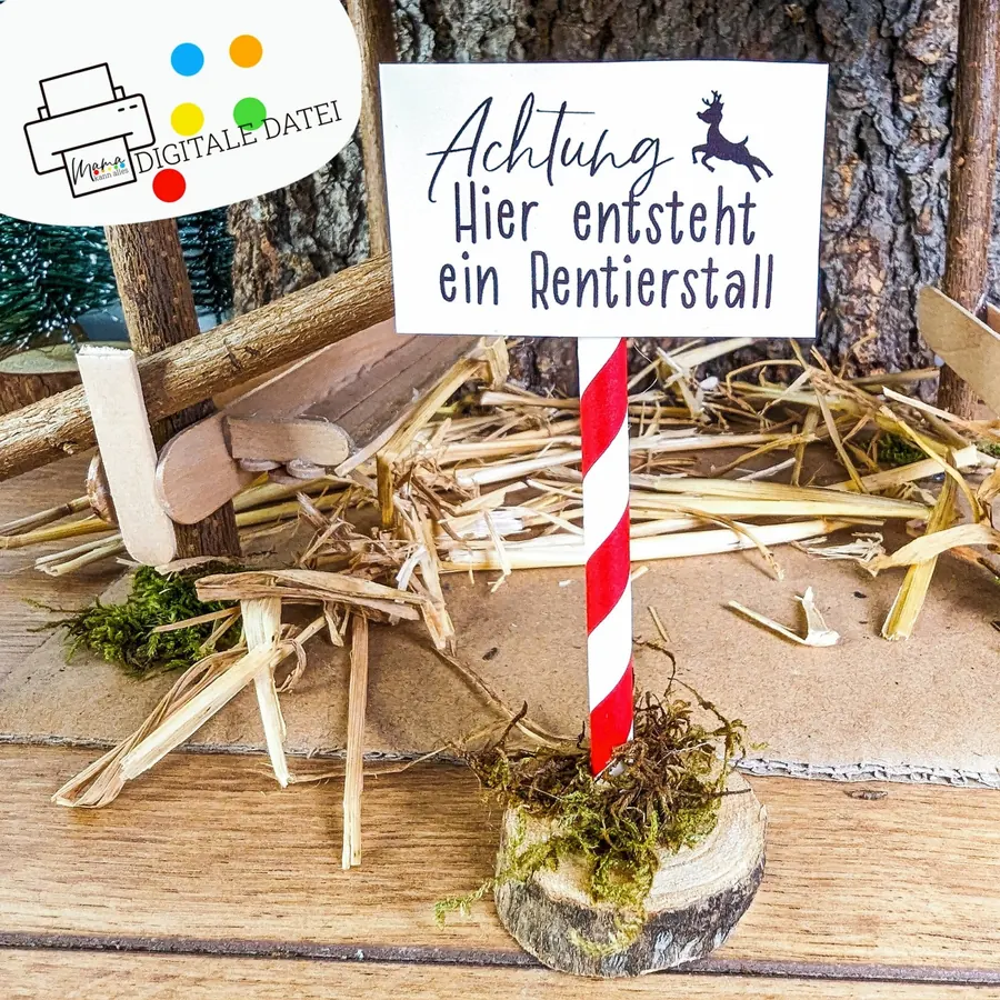 Schild Achtung, hier entsteht ein Rentierstall zwischen Stroh, Moos und Holz